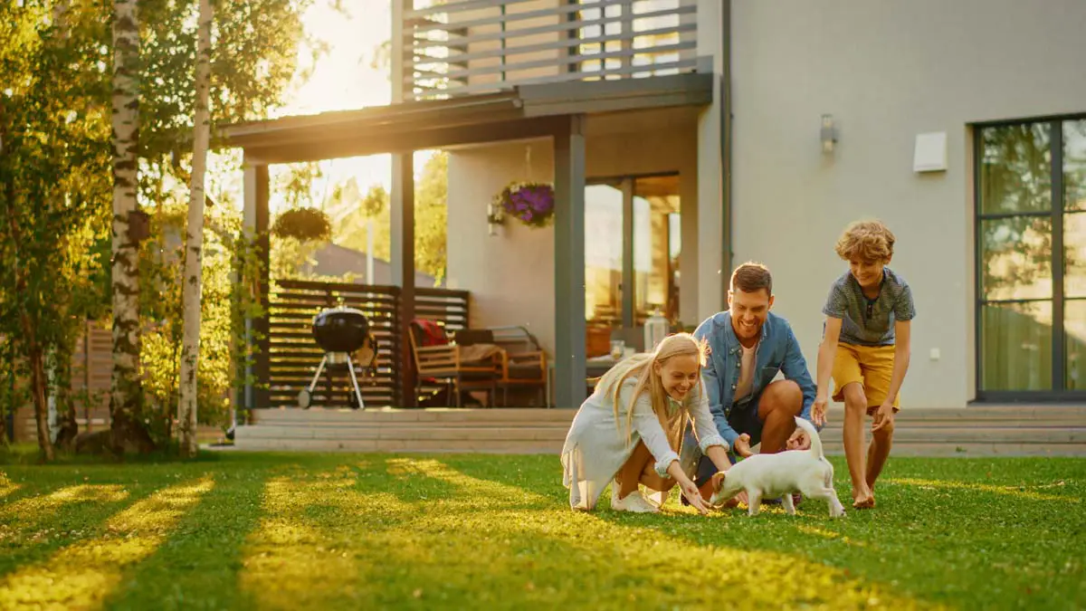 Family playing with their puppy in the backyard