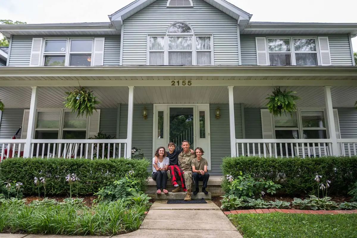 Family gathered on the front porch of their home