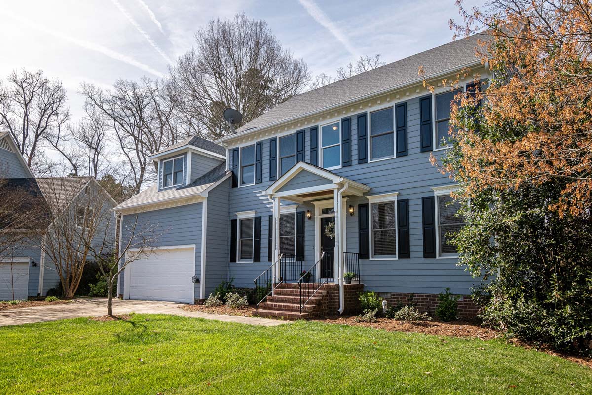 Modest blue suburban home with a front porch