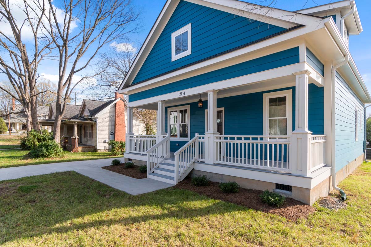 Bright blue suburban home with a tidy front yard