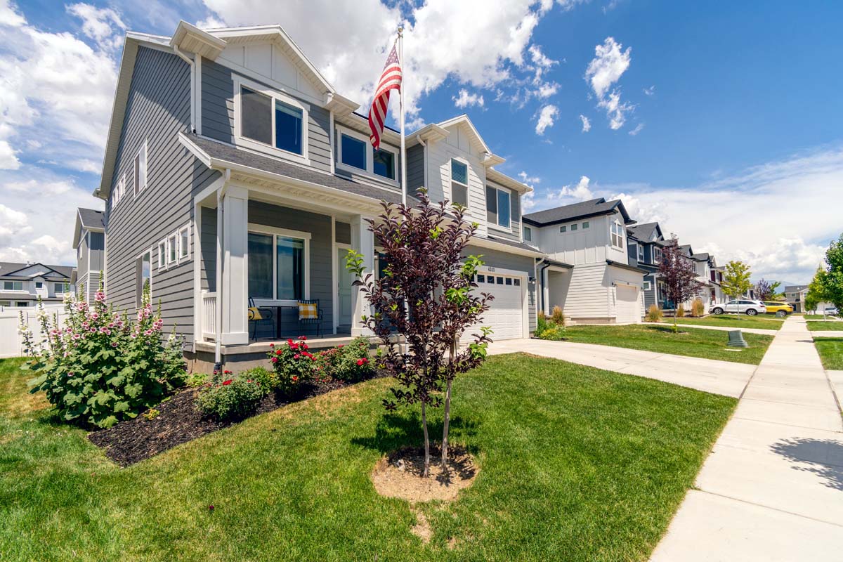 Suburban home displaying an American flag on the front facade