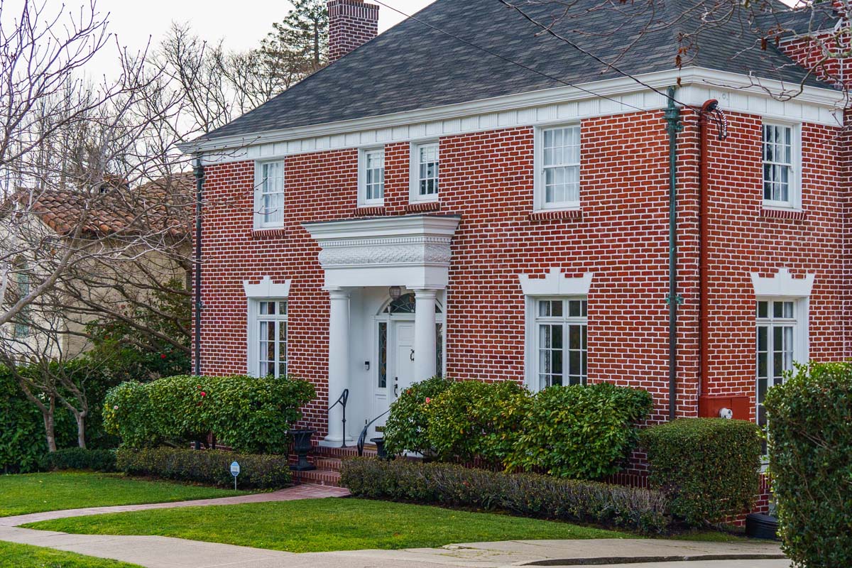 Large red brick home with a wide lot