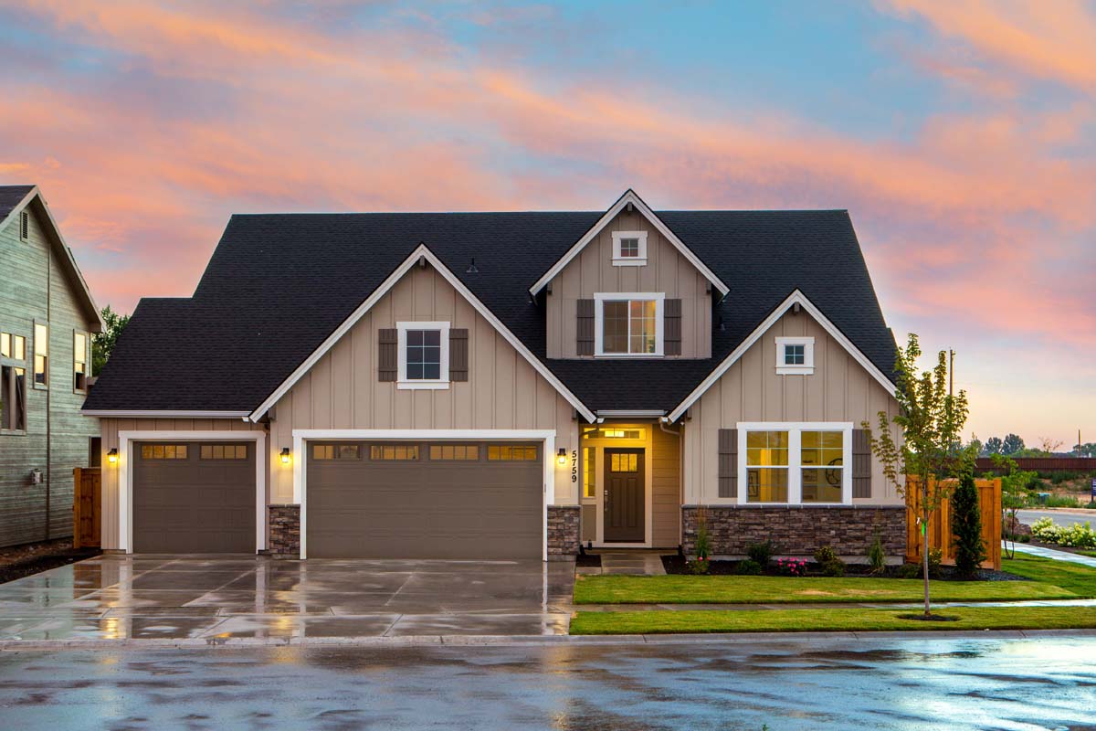Tan suburban home lit warmly in the evening