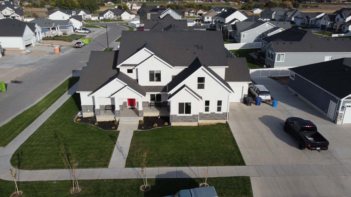 Spacious white home with landscaped grounds